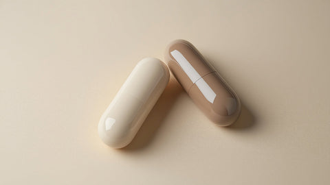 Close-Up of Two Capsules in Different Colors on a Neutral Background. L-tryptophan vs. 5-HTP: Which is Better?