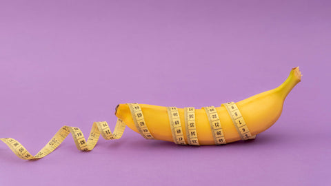 Inulin Weight Loss: Can It Really Help You Drop Those Pounds? Yellow banana which is a source of inulin fiber wrapped with measuring tape on purple background, 