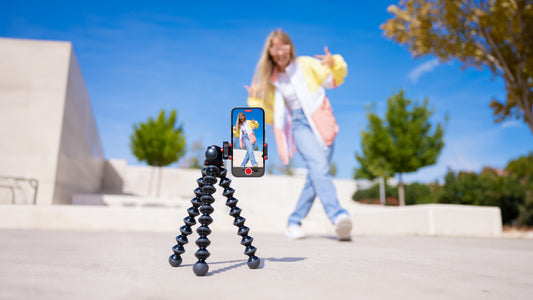 Tripod with iphone set up to record a girl creating a TikTok whilst walking backward.